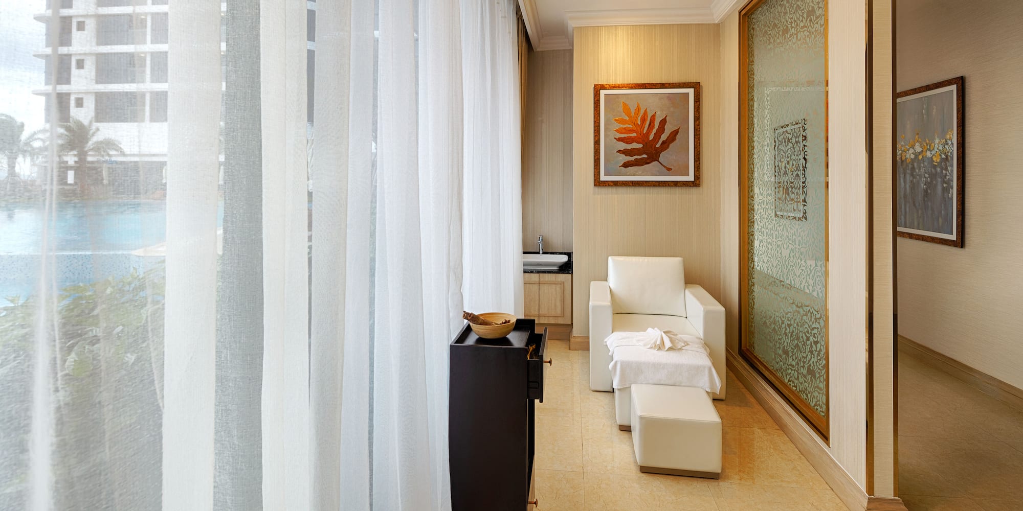 a room with white curtains and a white chair