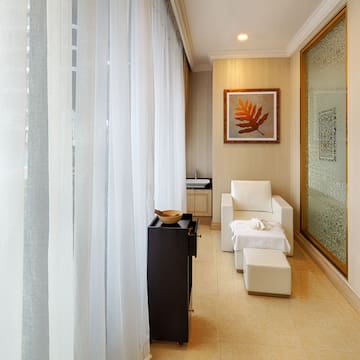 a room with white curtains and a white chair