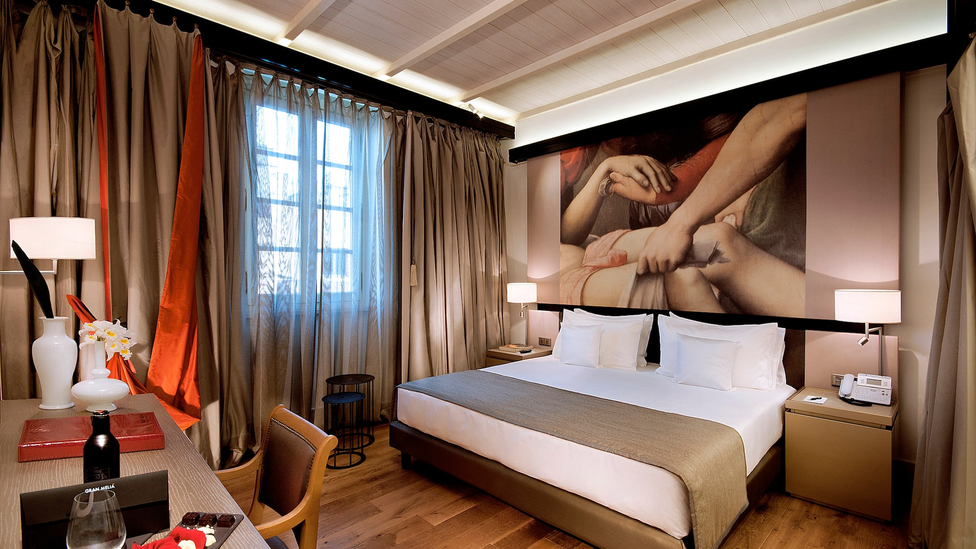 a room with a bed and a table and chairs