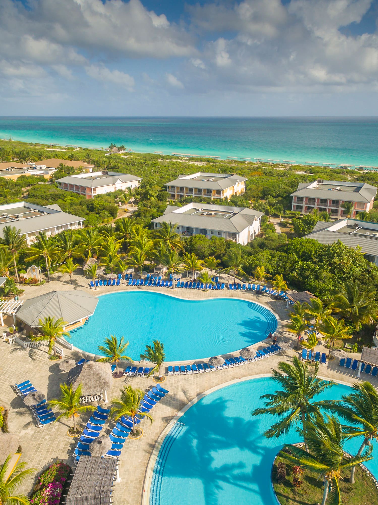 a swimming pool surrounded by trees and buildings