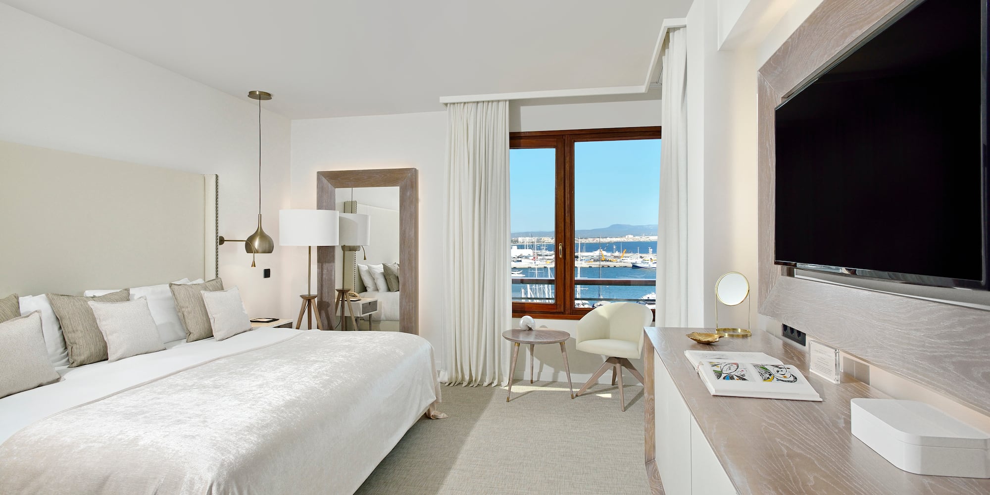 a bedroom with a large bed and a television