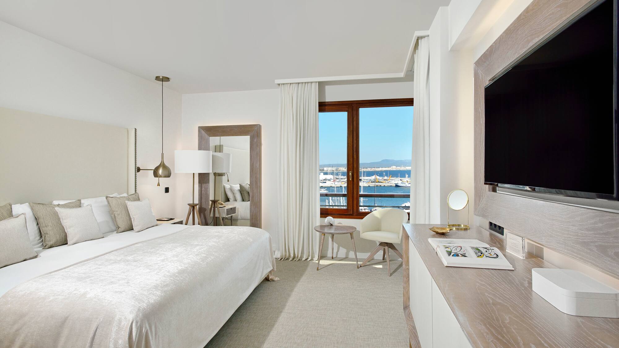 a bedroom with a large bed and a television