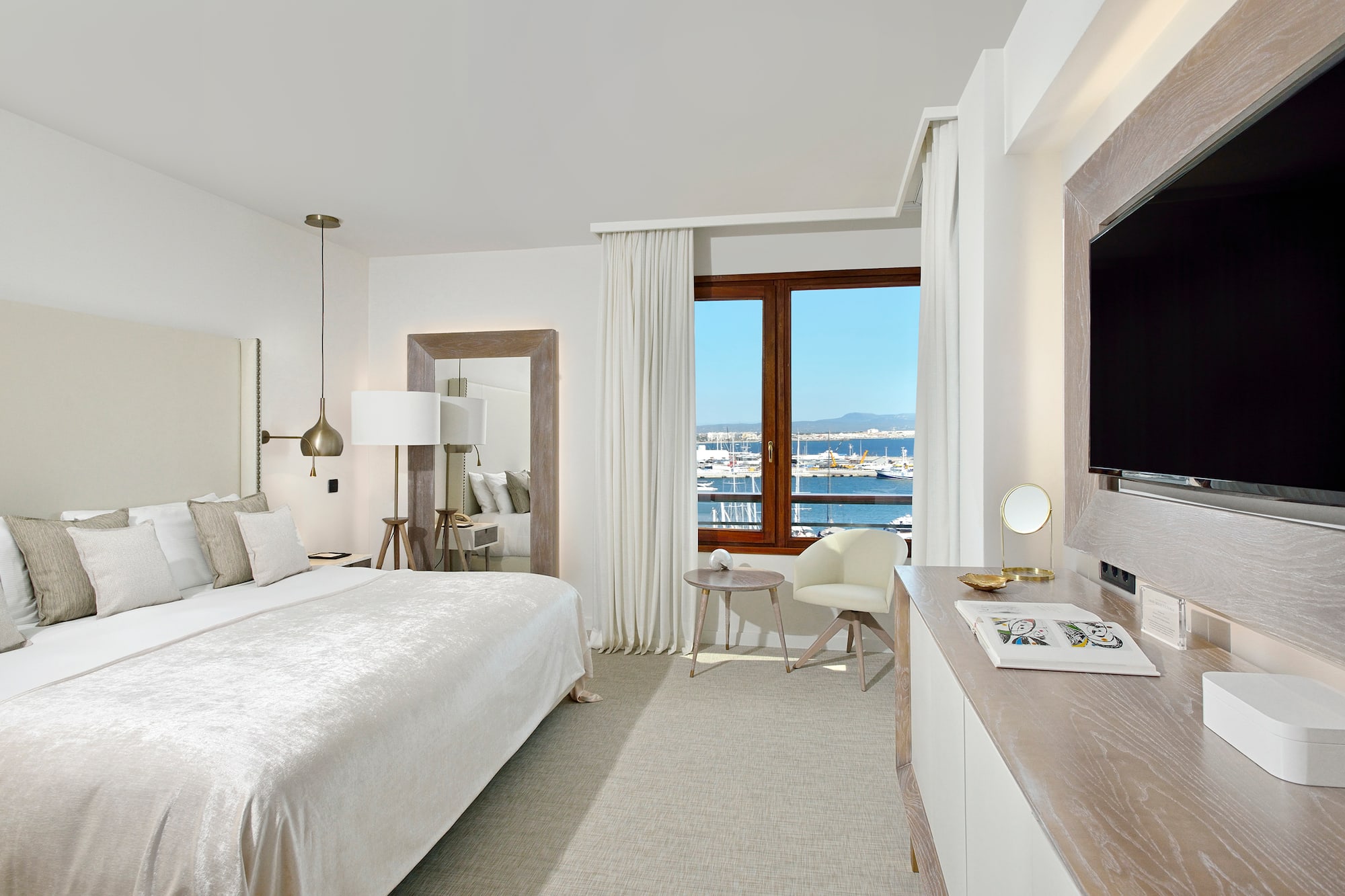 a bedroom with a large bed and a television