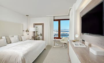 a bedroom with a large bed and a television