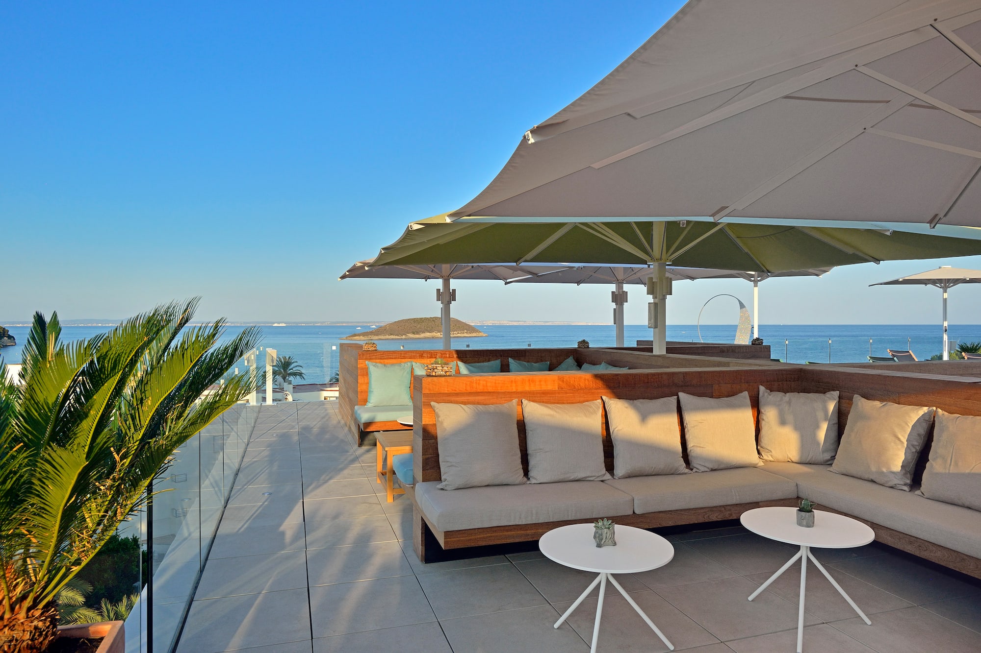 a patio with a large umbrella and couches