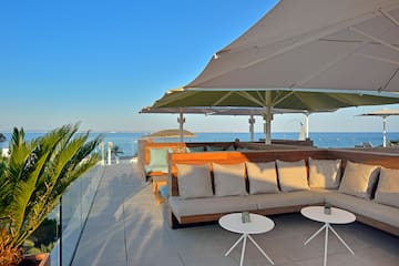 a patio with a large umbrella and couches