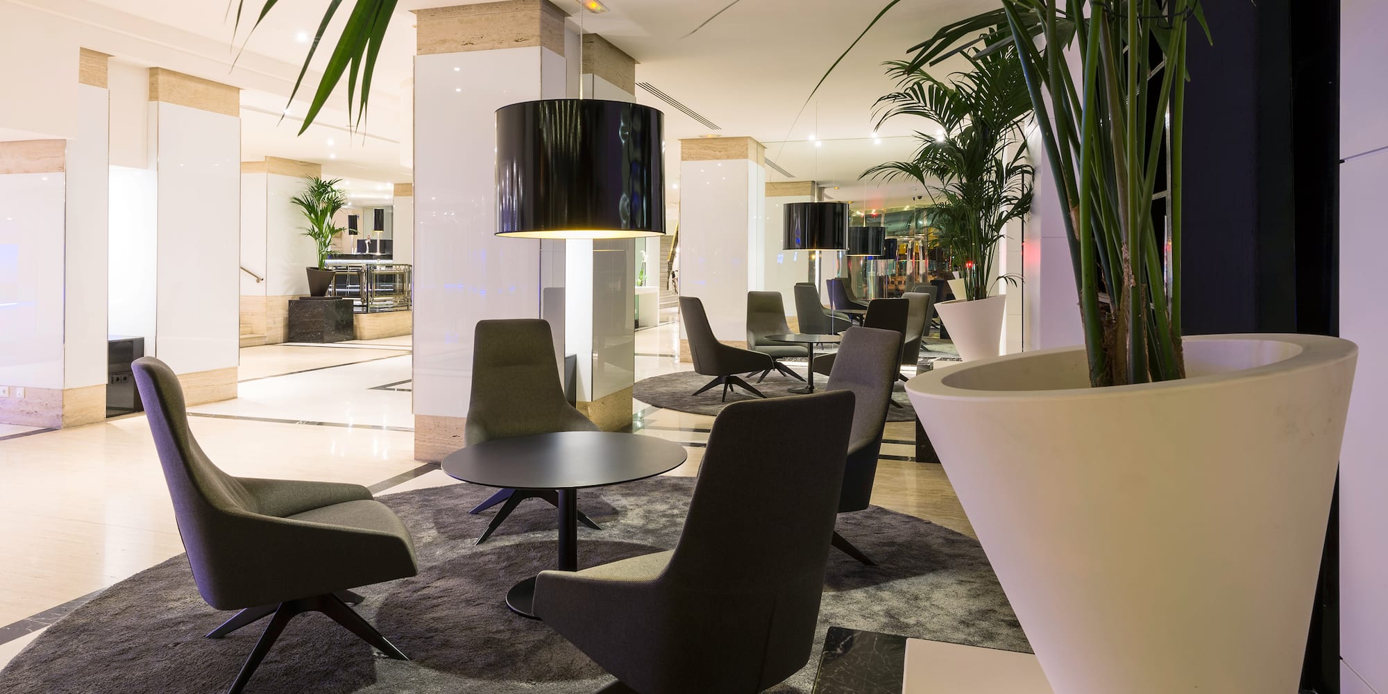 a room with chairs and a lamp