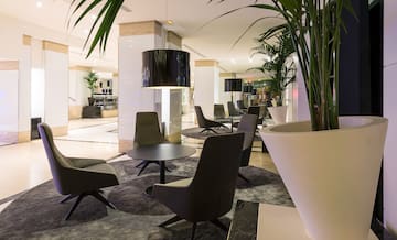 a room with chairs and a lamp