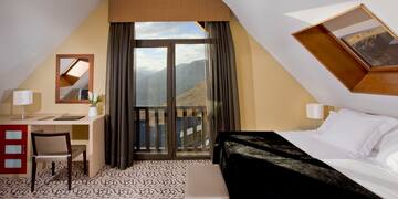 a bedroom with a view of mountains