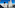 a two tall buildings with a street and a blue sky