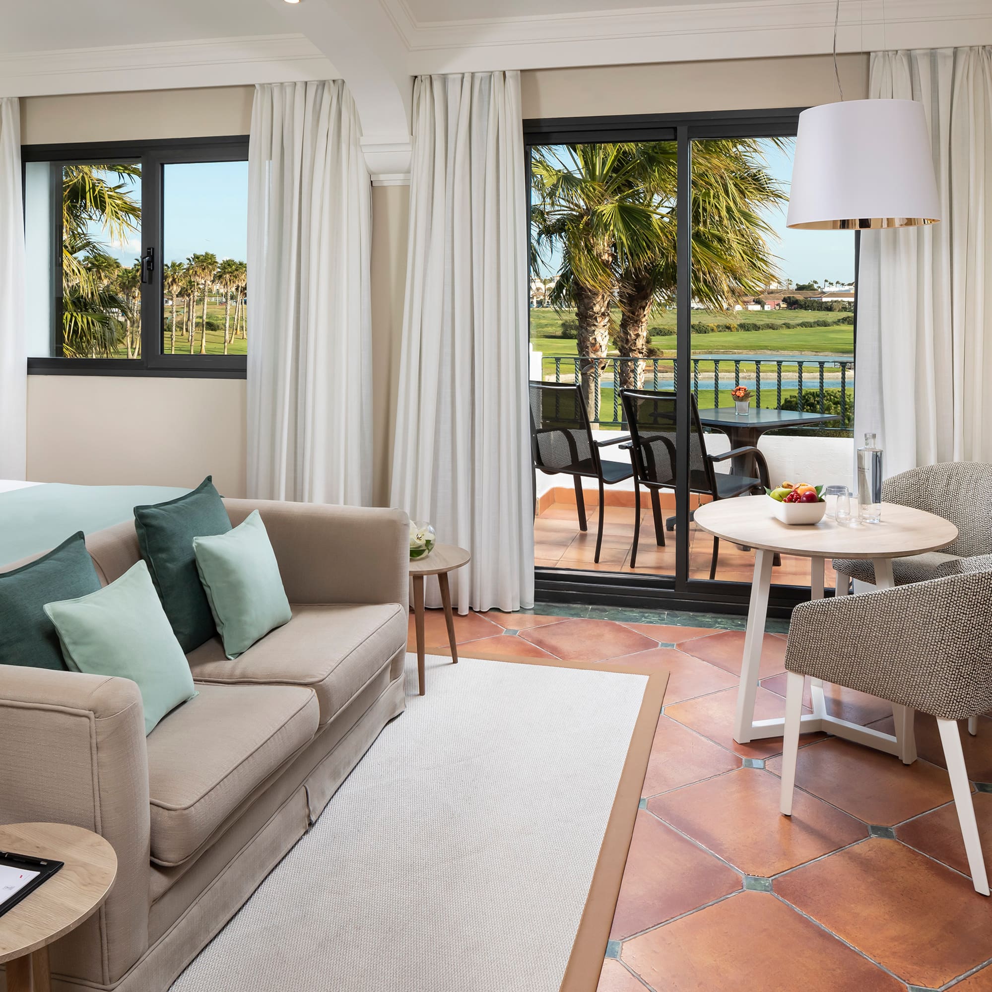 a room with a couch and a table and chairs