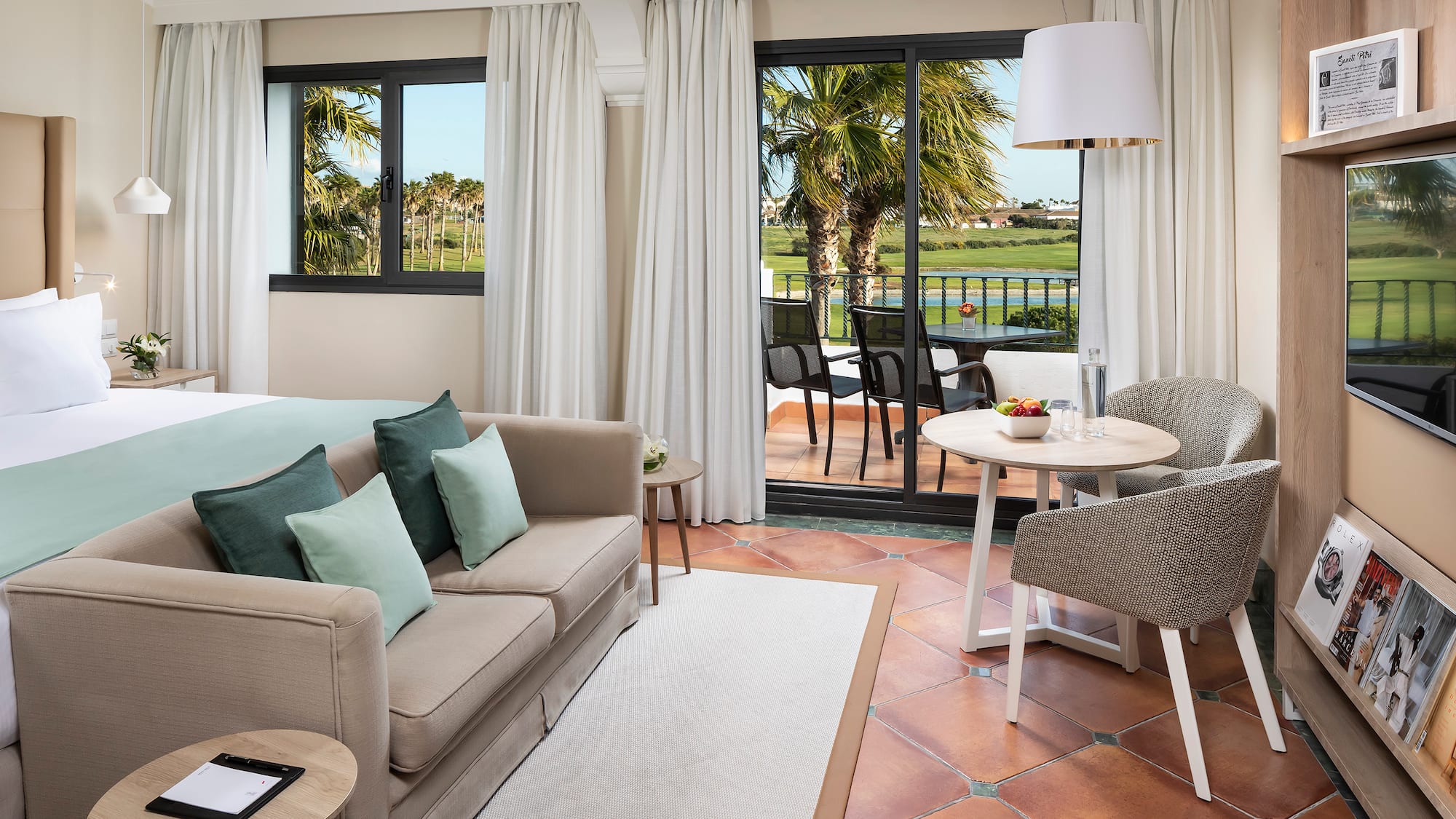 a room with a couch and a table and chairs