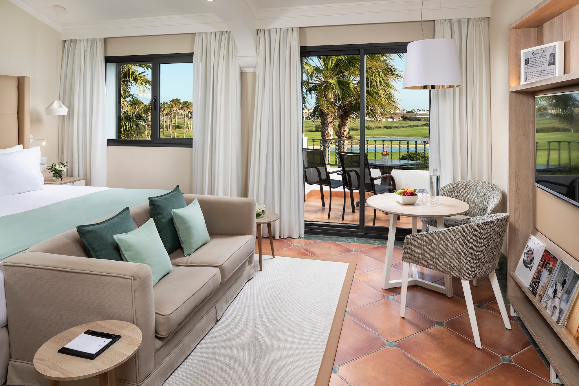 a room with a couch and a table and chairs