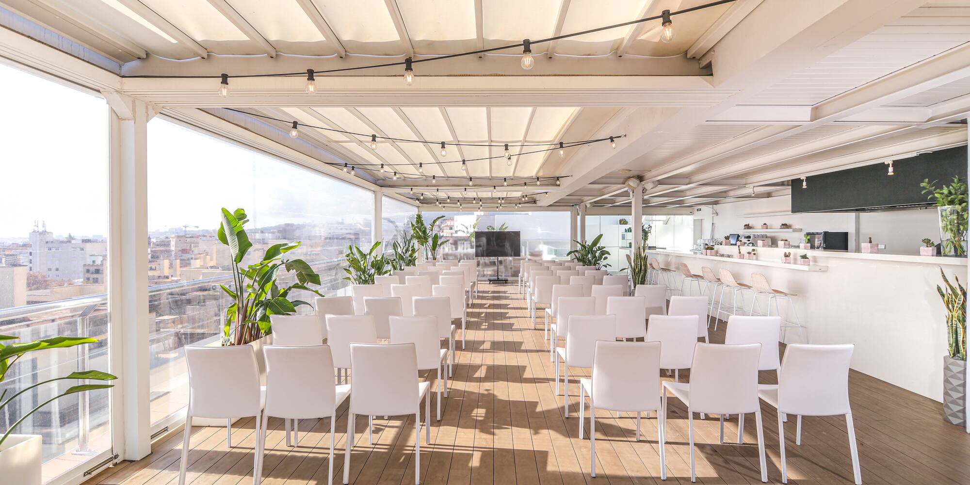 a room with white chairs and tables
