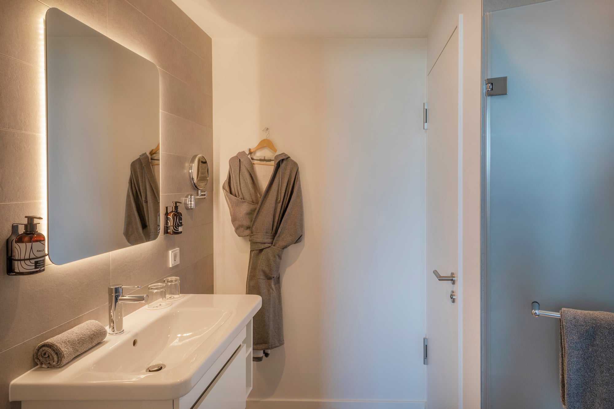 a bathroom with a bathrobe and sink