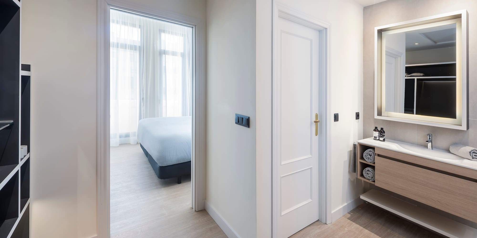 a bathroom with a mirror and a bed