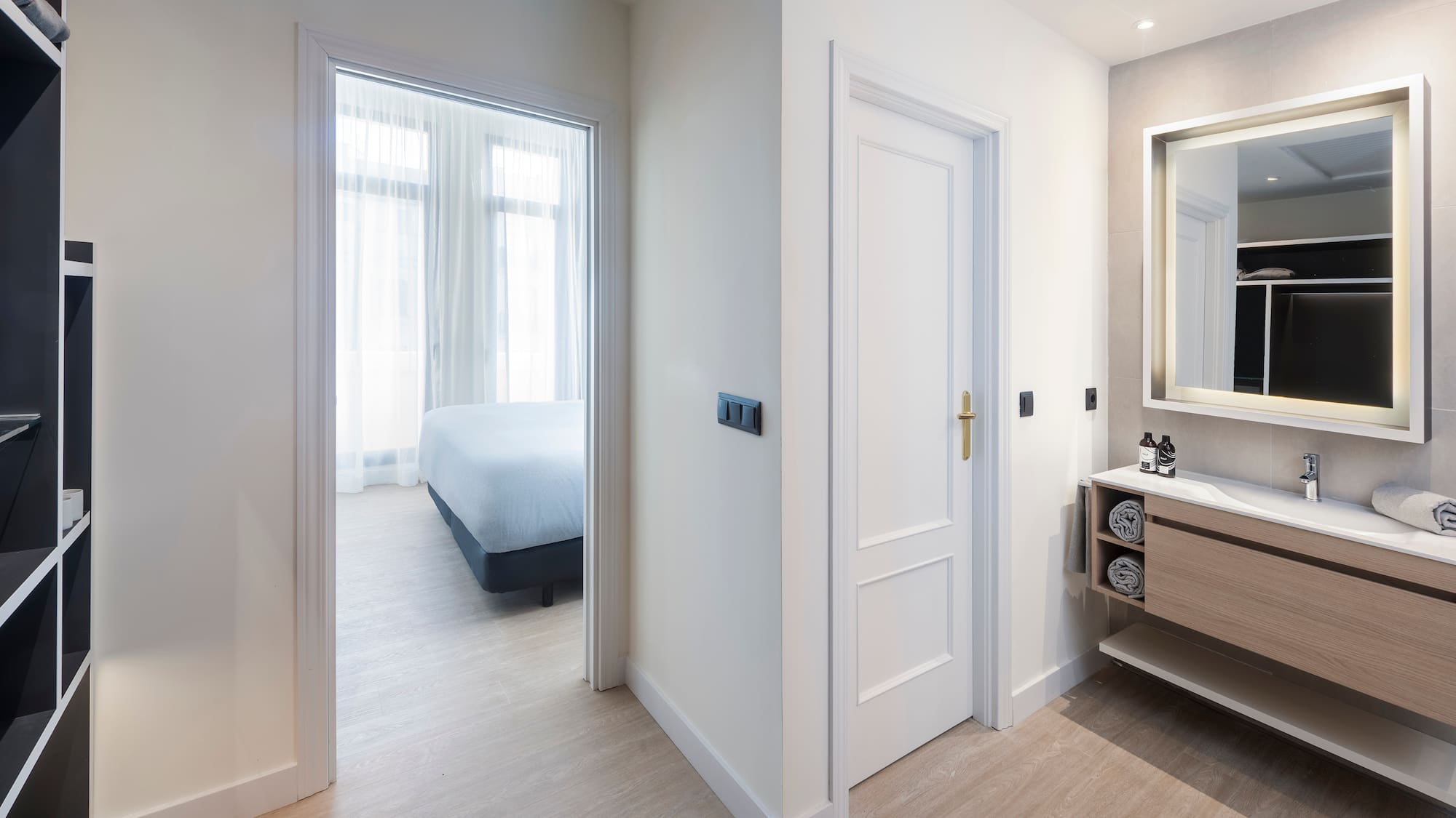 a bathroom with a mirror and a bed