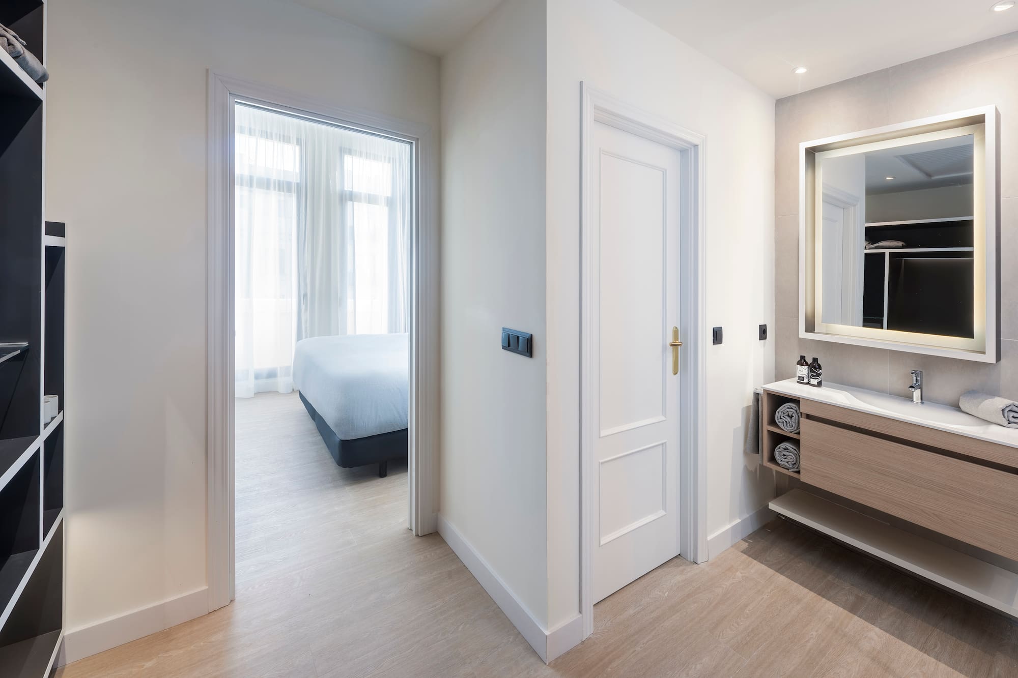 a bathroom with a mirror and a bed