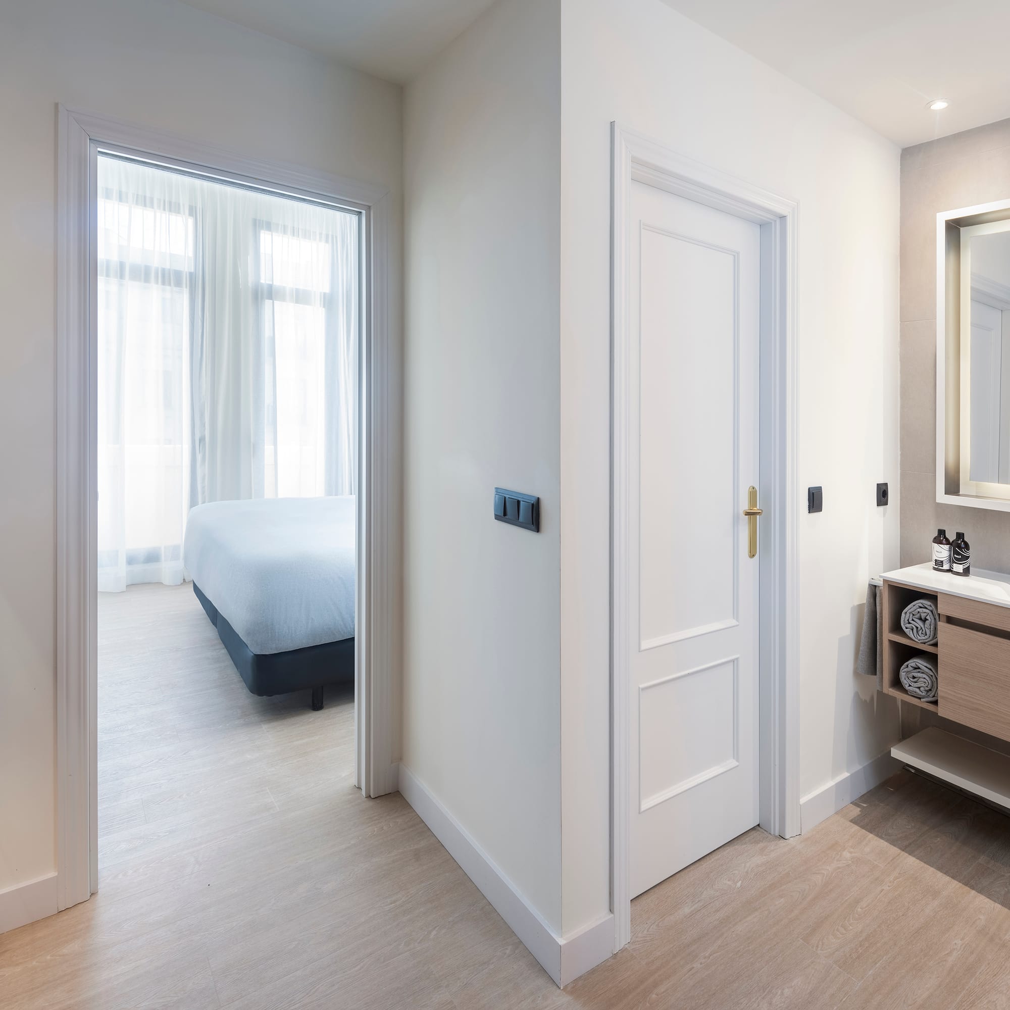 a bathroom with a mirror and a bed