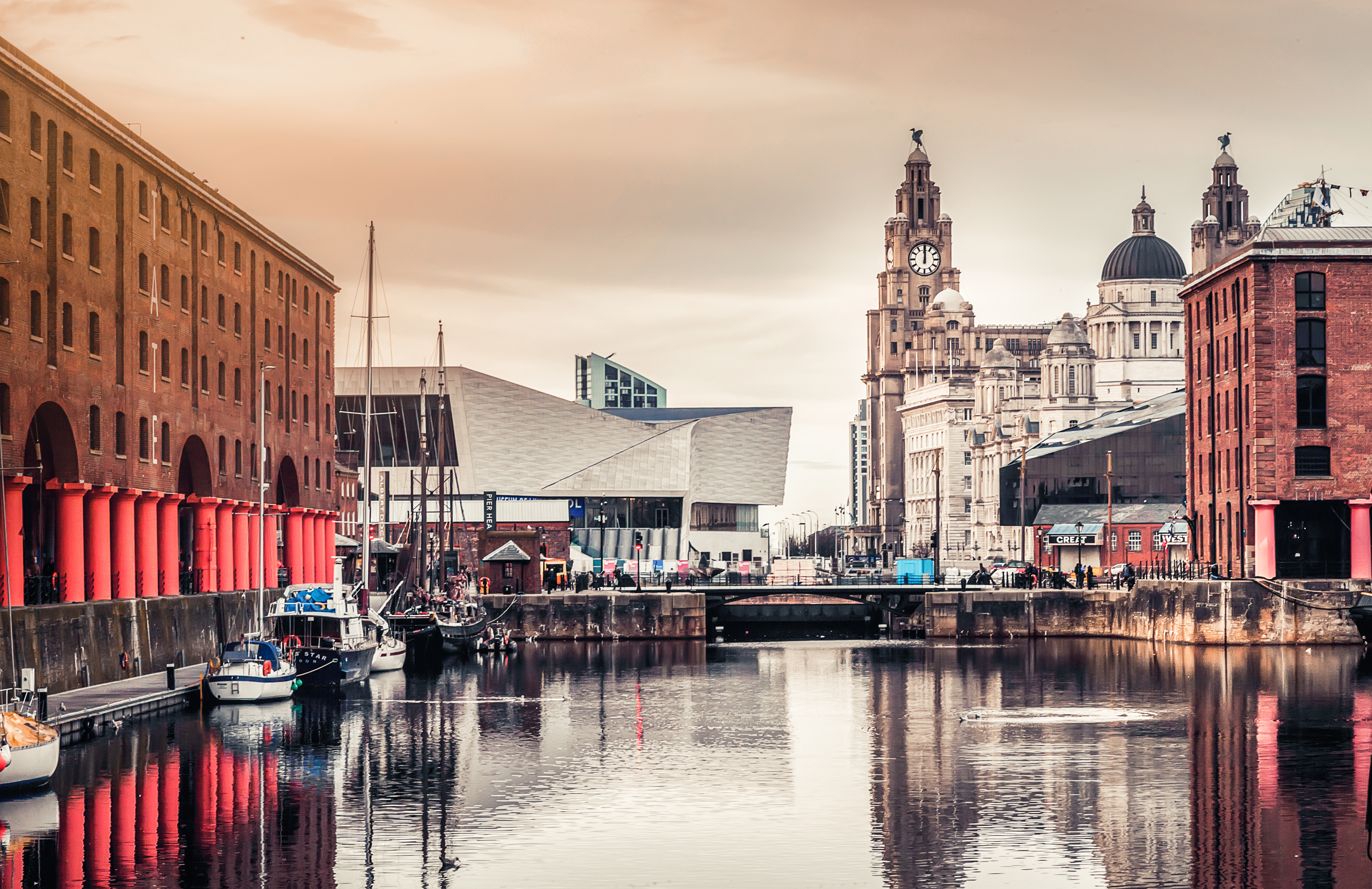 a body of water with boats and buildings in the background