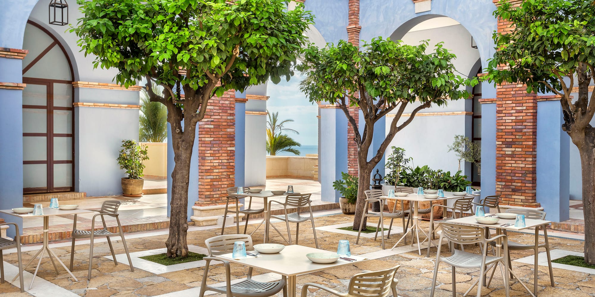 a patio with tables and chairs