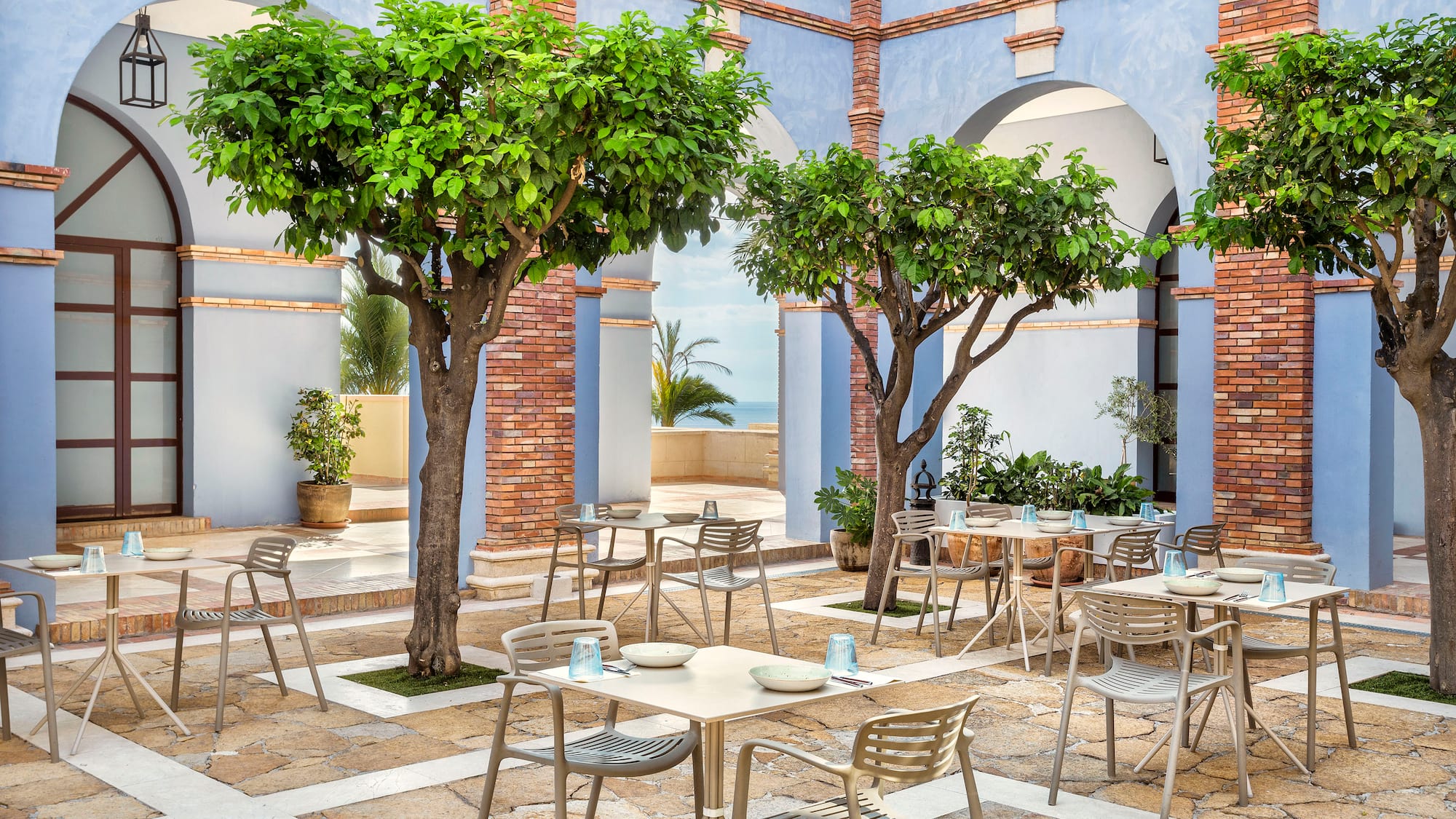 a patio with tables and chairs