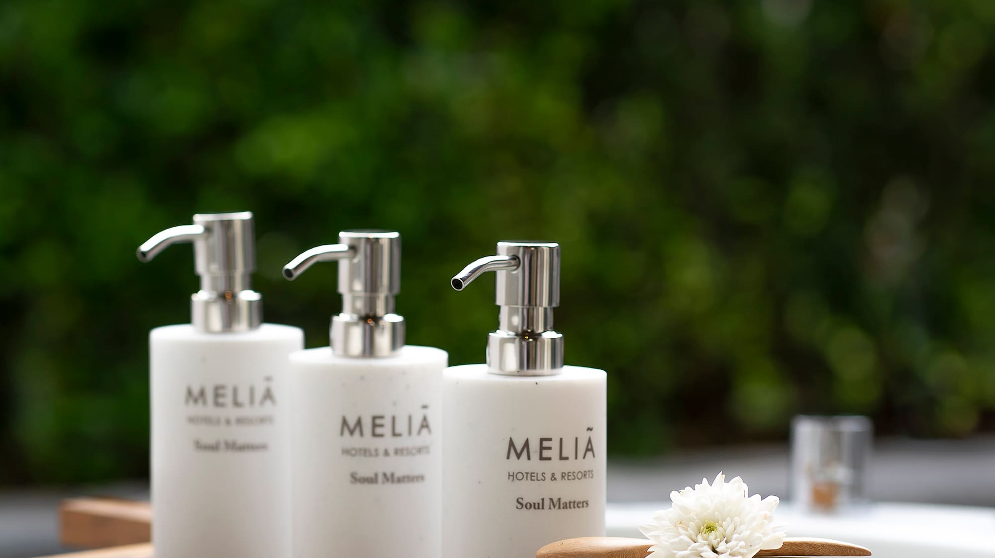 a group of white bottles on a wooden tray