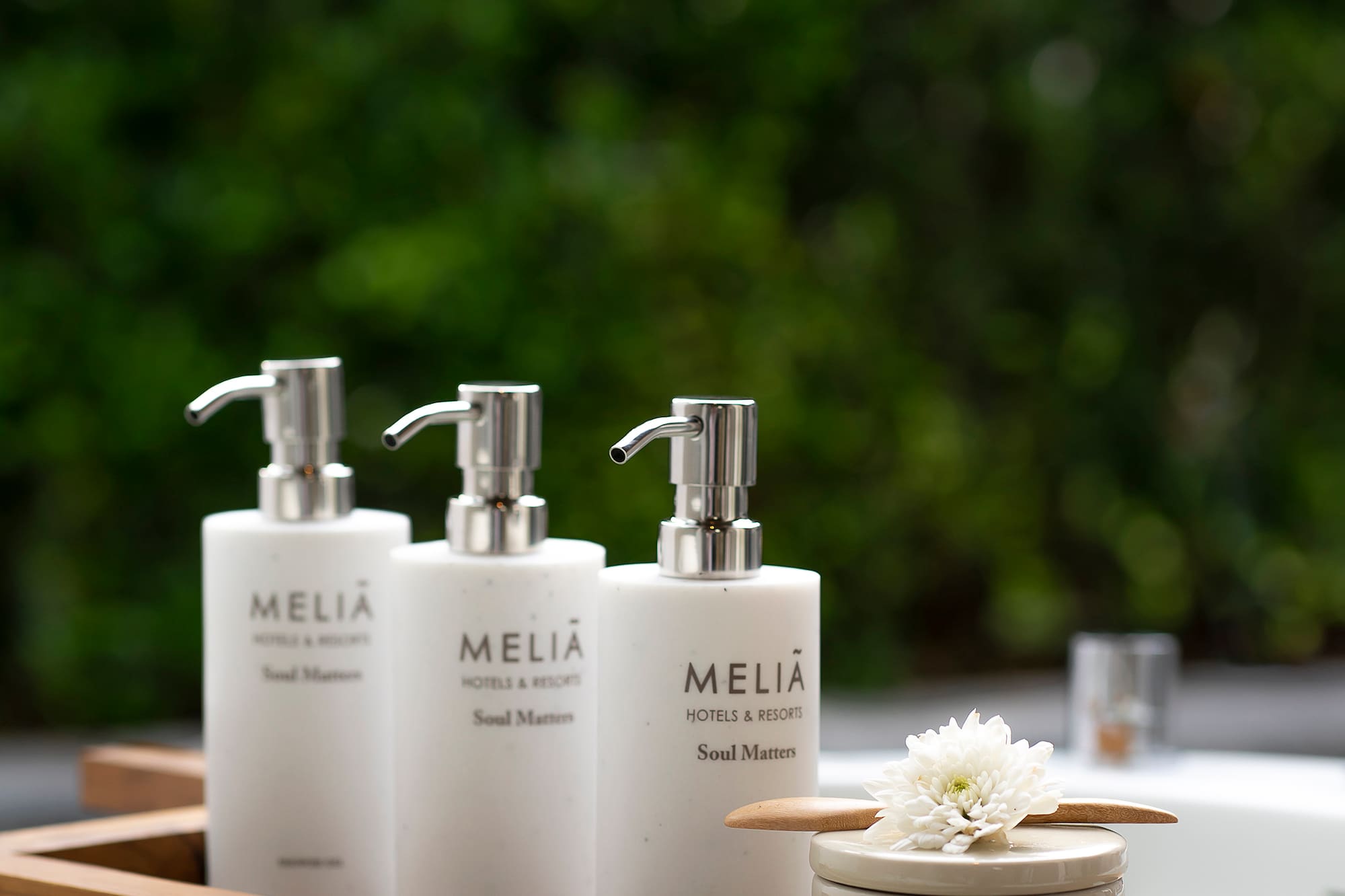 a group of white bottles on a wooden tray