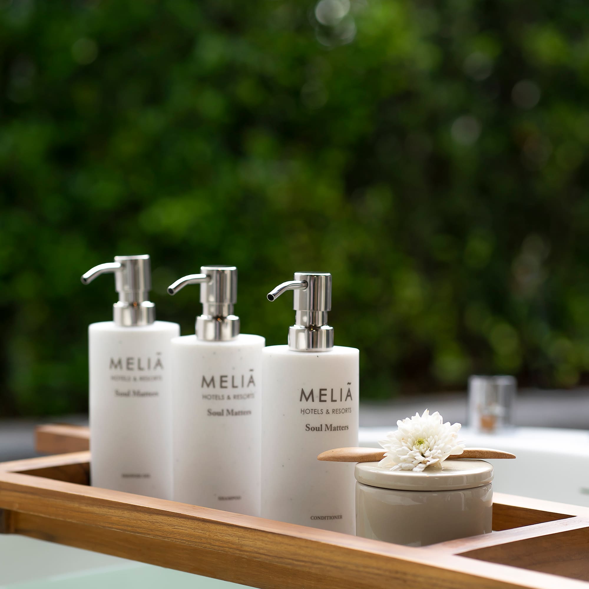 a group of white bottles on a wooden tray