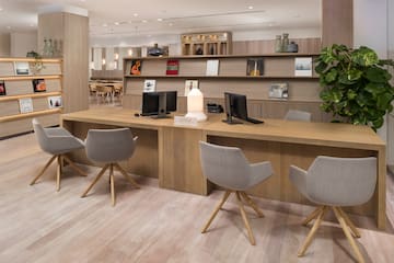 a room with a desk and chairs