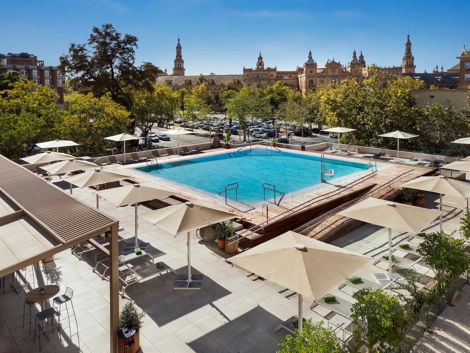 a pool with umbrellas and trees in the background