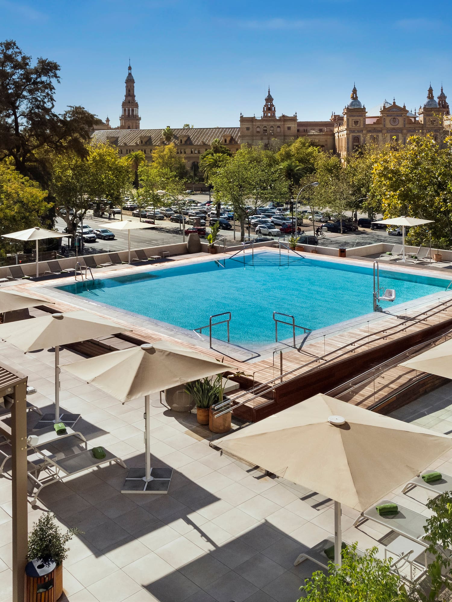 a pool with umbrellas and trees in the background