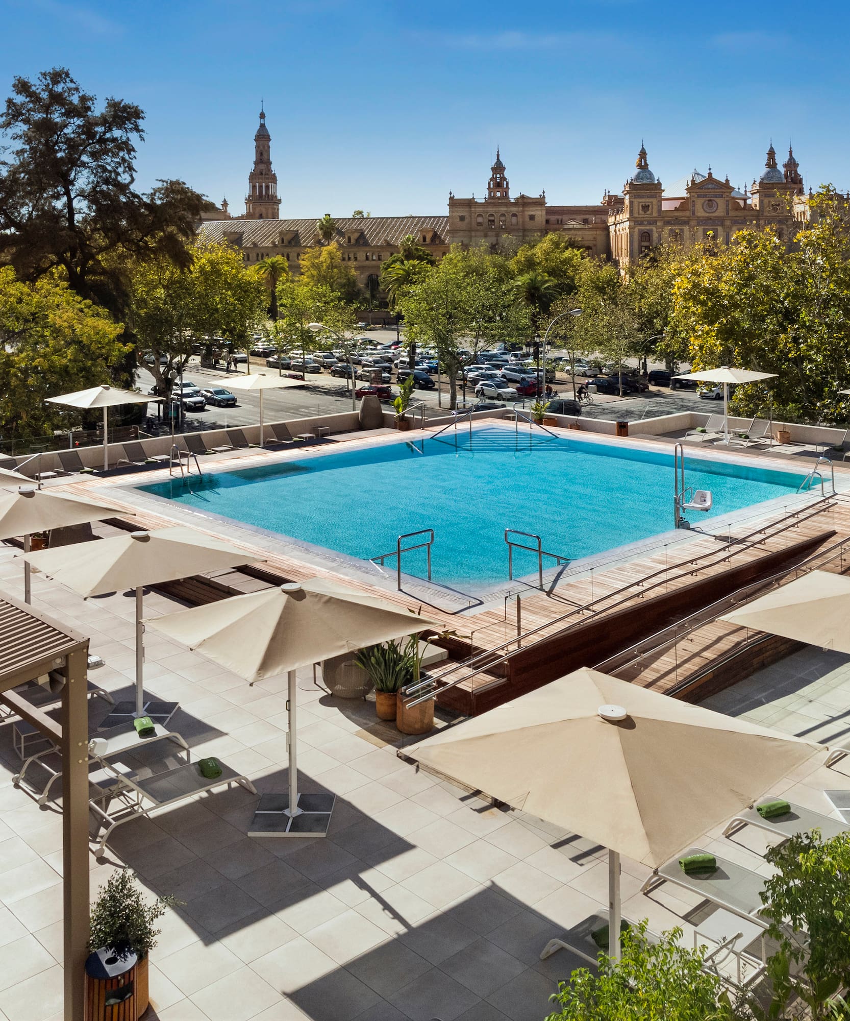 a pool with umbrellas and trees in the background