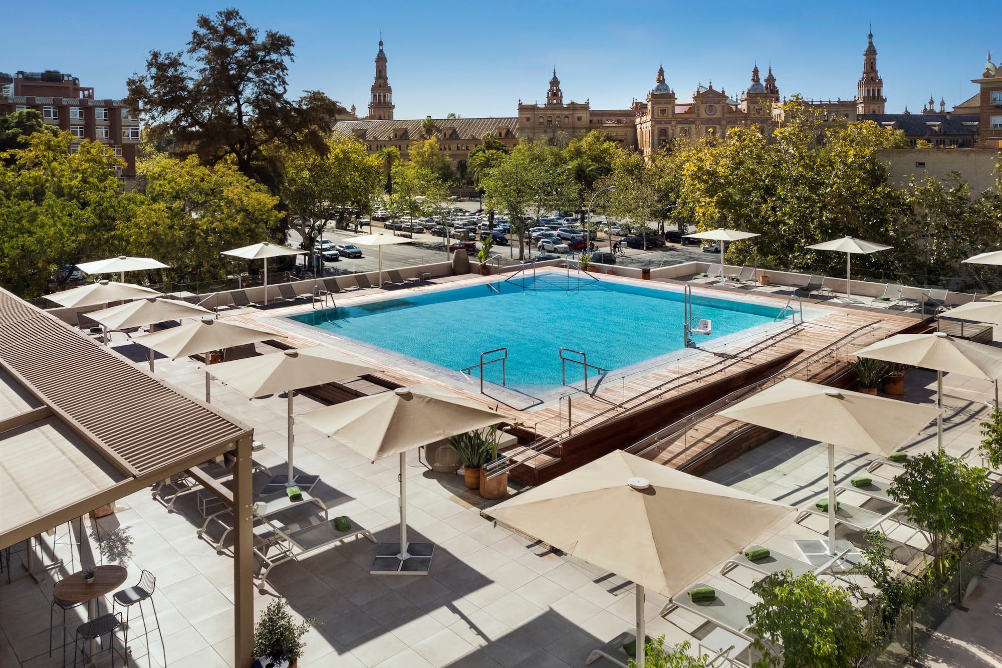 a pool with umbrellas and trees in the background