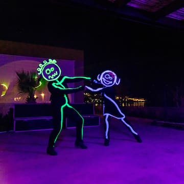 a man and woman dancing with lights