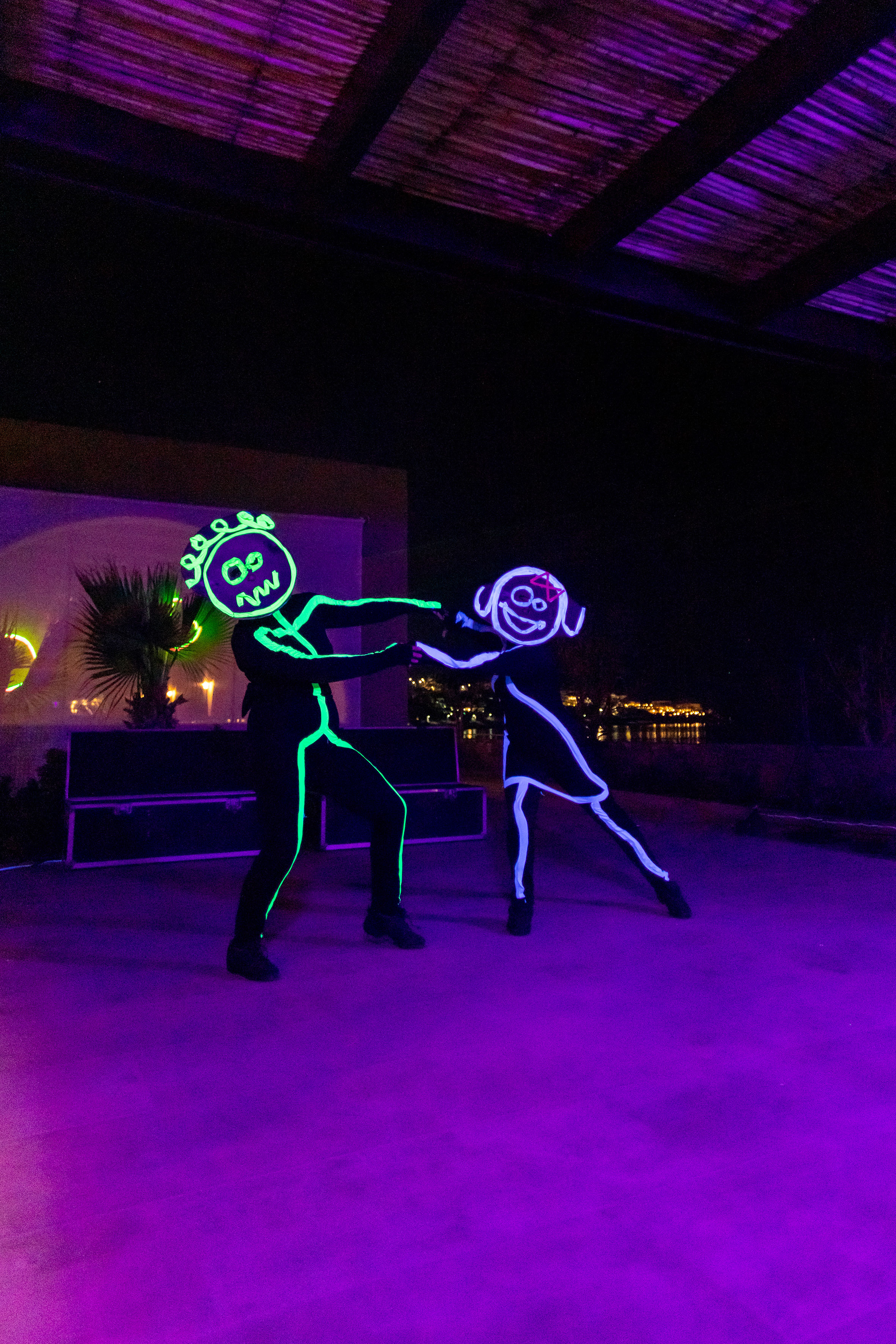a man and woman dancing with lights