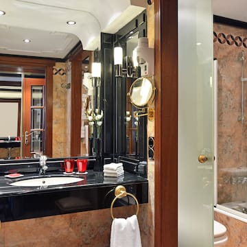 a bathroom with a black countertop and a shower