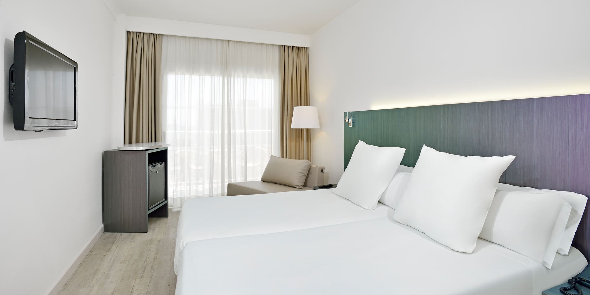 a room with white sheets and a table