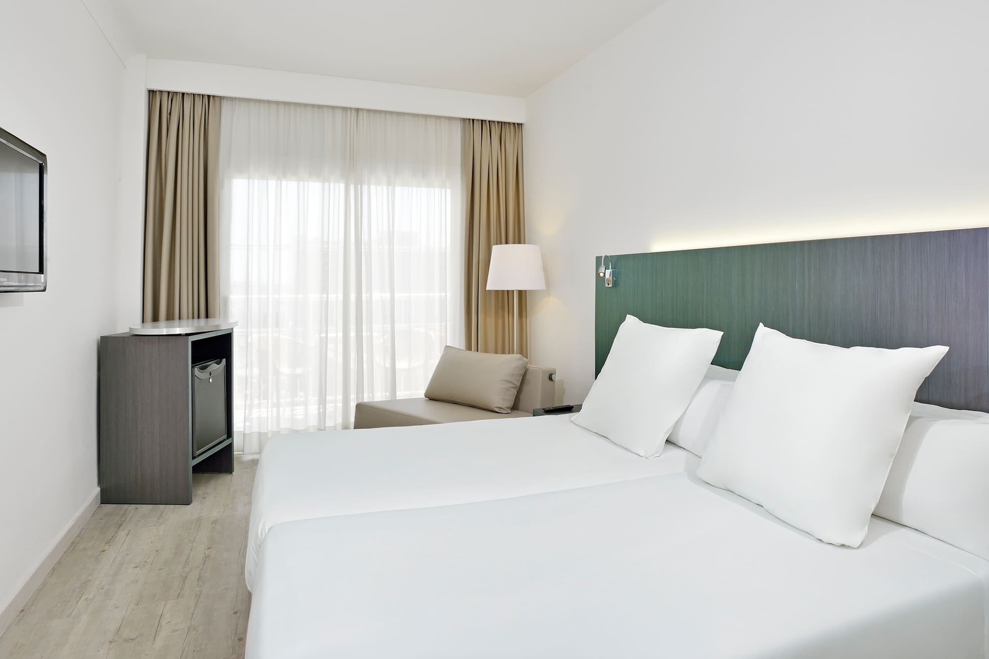 a room with white sheets and a table