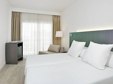 a room with white sheets and a table
