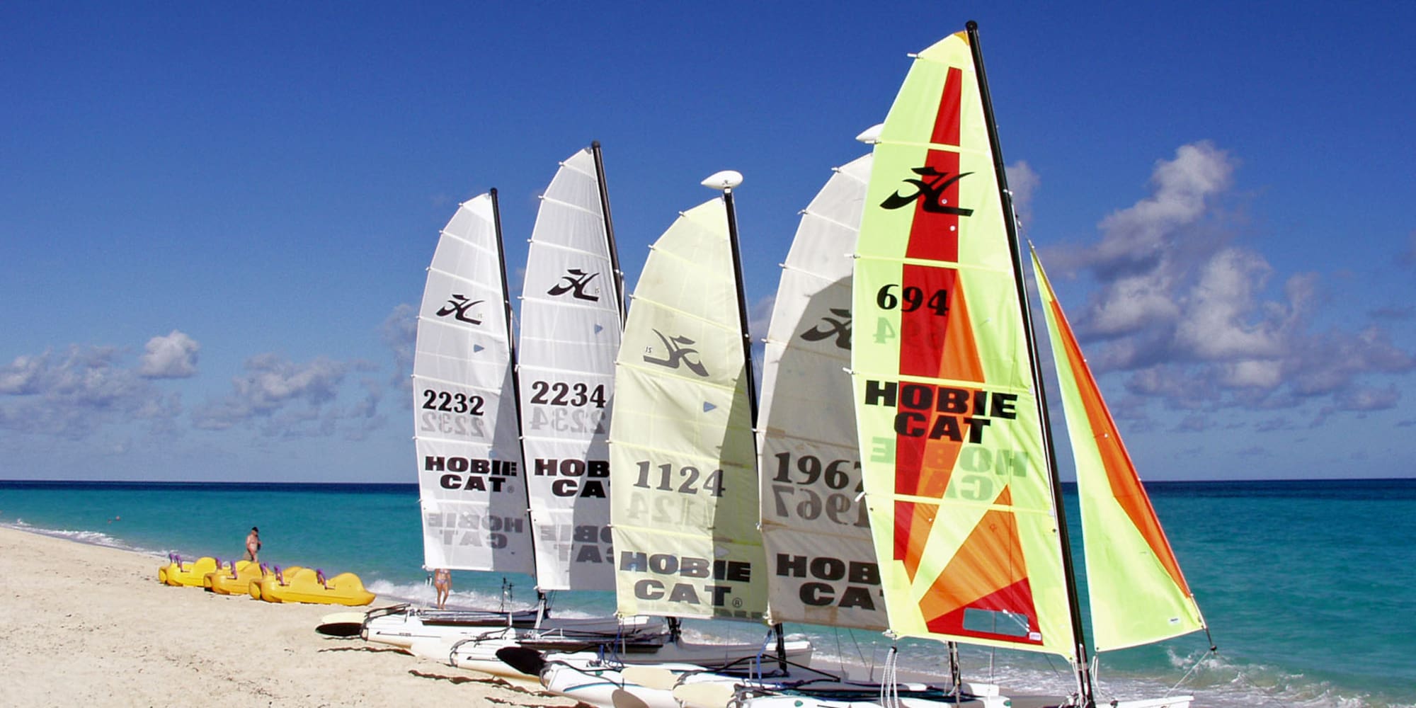 a group of sailboats on a beach