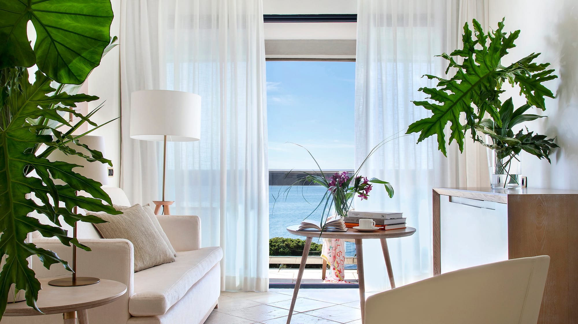 a living room with a couch and a table and chairs