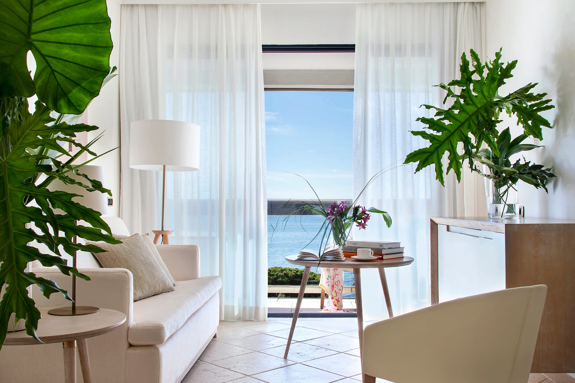 a living room with a couch and a table and chairs