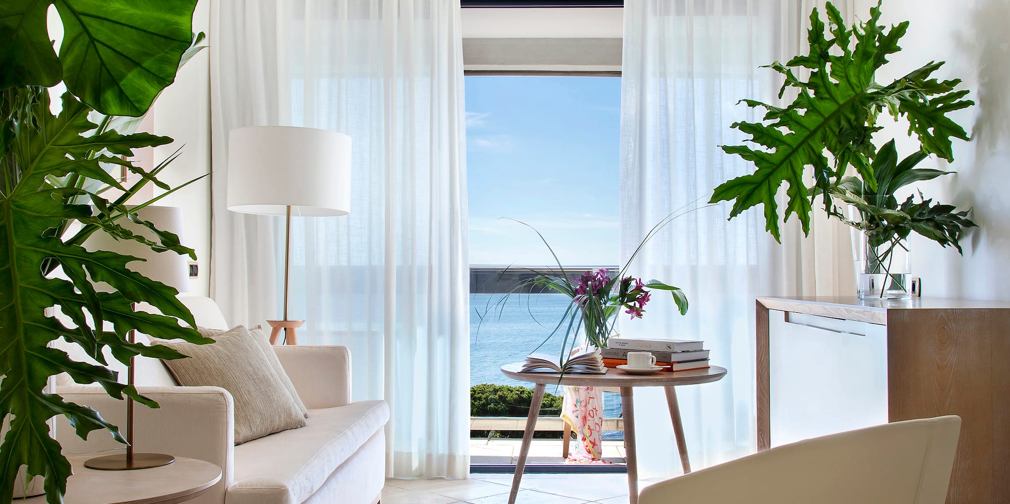 a living room with a couch and a table and chairs