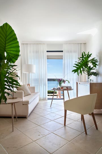 a living room with a couch and a table and chairs