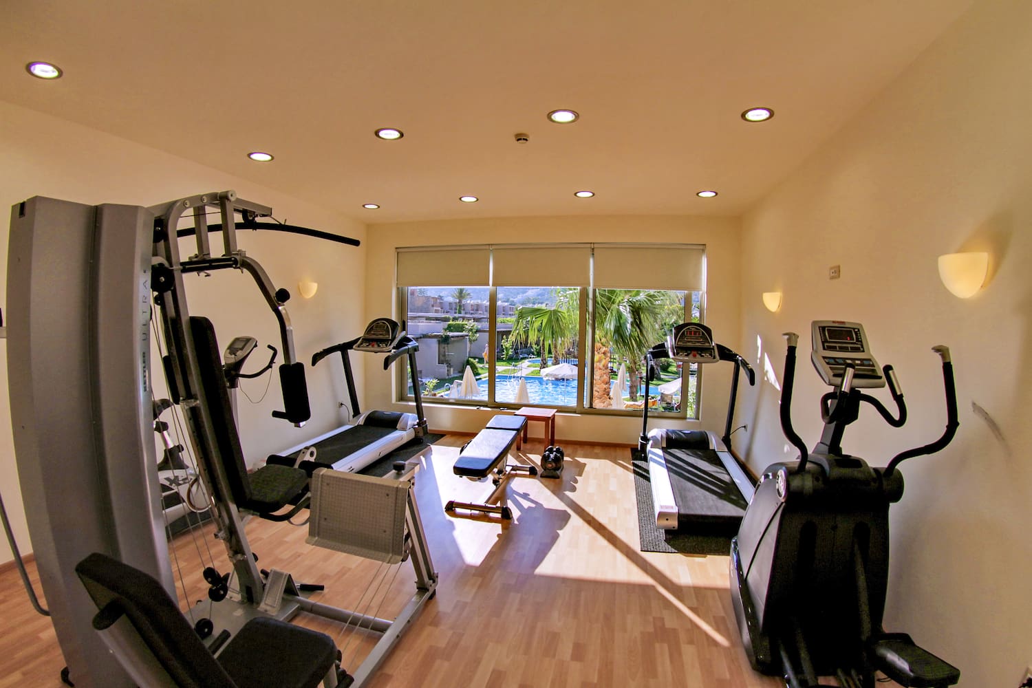 a room with exercise equipment and a window