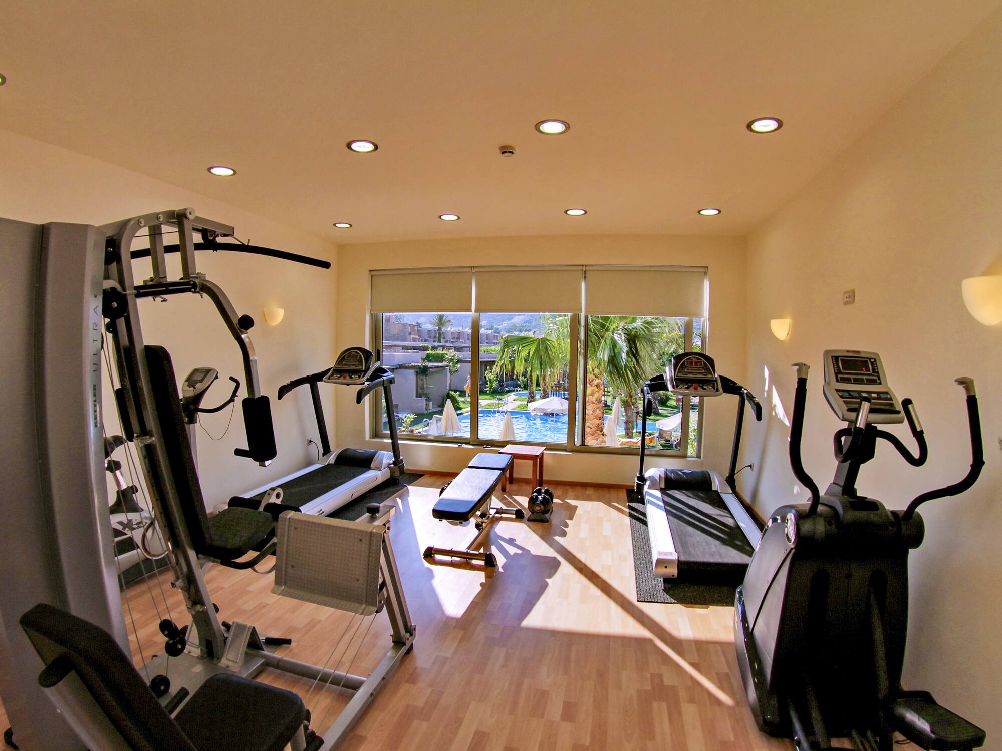 a room with exercise equipment and a window