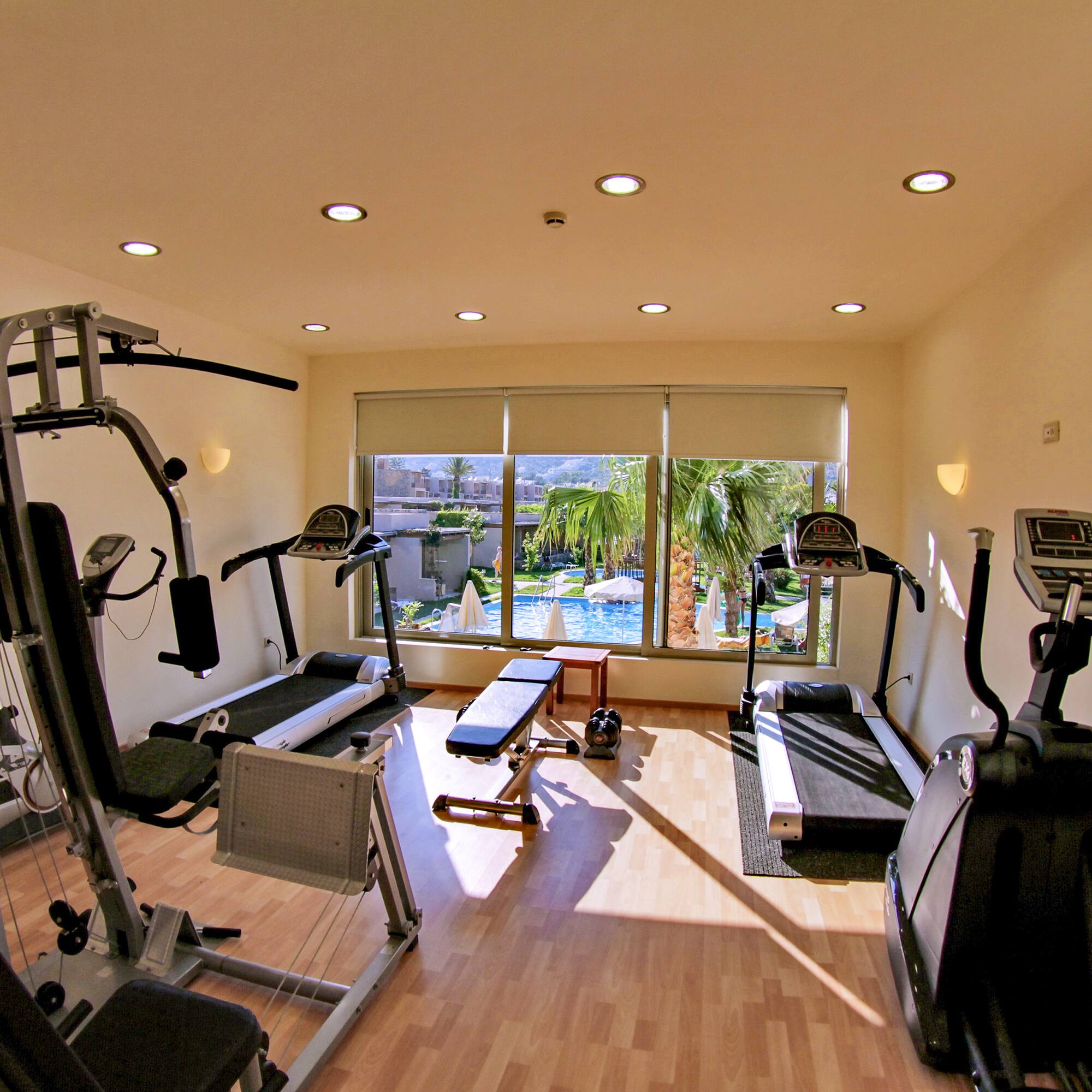 a room with exercise equipment and a window