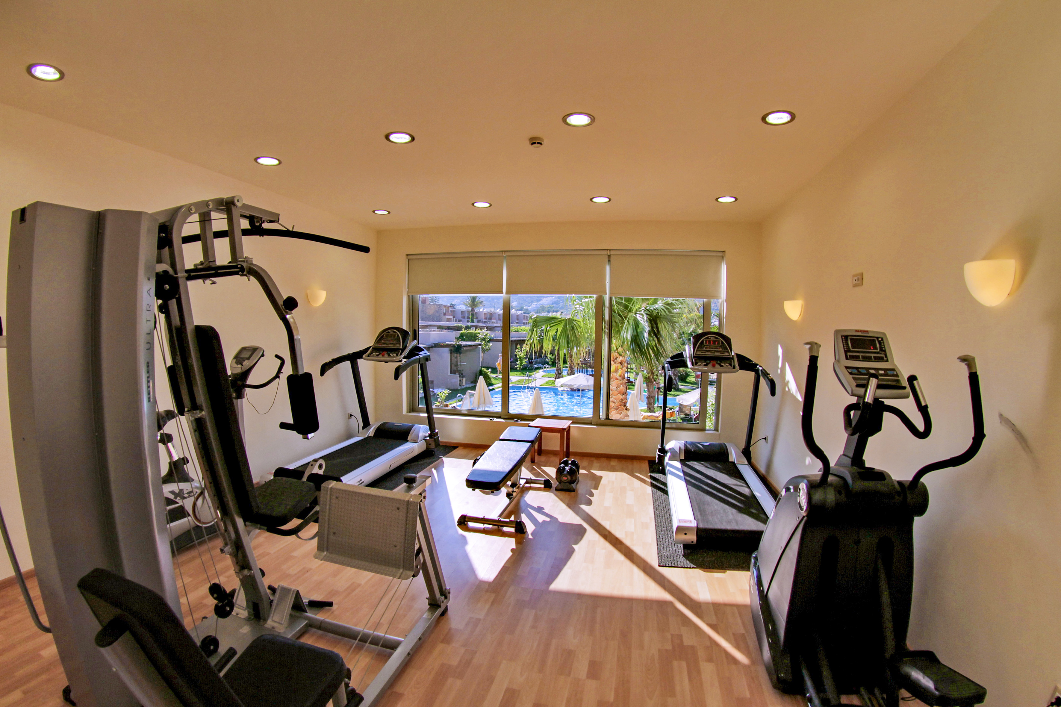 a room with exercise equipment and a window