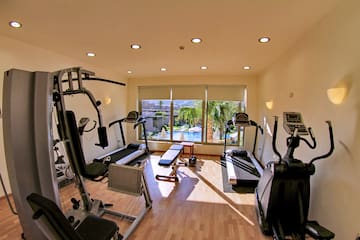 a room with exercise equipment and a window